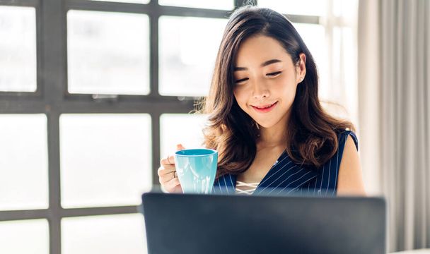 Biznes azjatycka kobieta pracuje z laptopem komputera i pić kawy. Kreatywne ludzi biznesu planuje w nowoczesnym poddaszu pracy - Zdjęcie, obraz