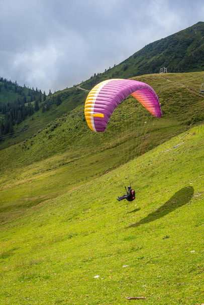 Westendorf / Austria - August 08 2019: Mountain valley paragliding scene. - Fotó, kép