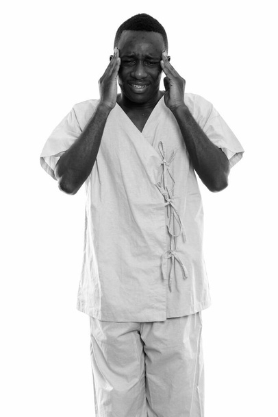 Studio shot of young African man as hospital patient isolated against white background in black and white - Fotó, kép