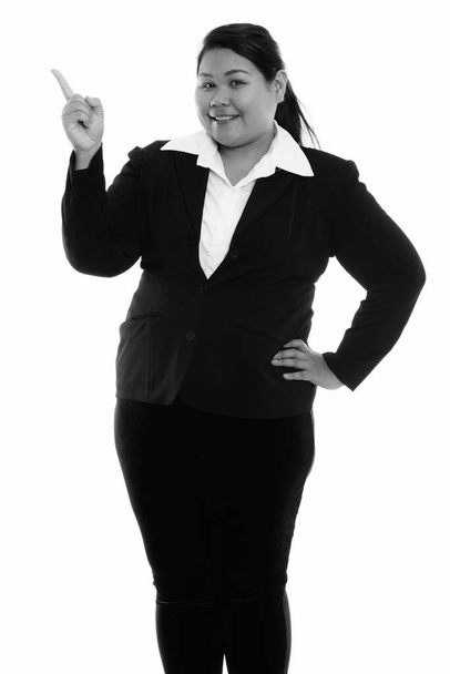 Studio shot of young beautiful overweight Asian businesswoman isolated against white background in black and white - Φωτογραφία, εικόνα