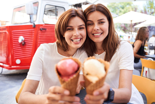 Girls enjoying delicious ice cream - Фото, изображение