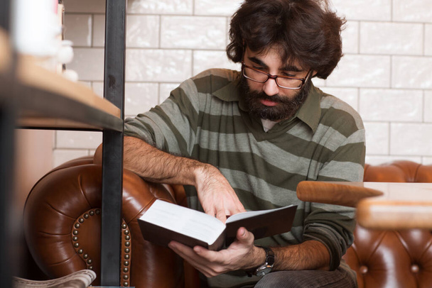 handsome bearded man wearing glasses reading book - Φωτογραφία, εικόνα