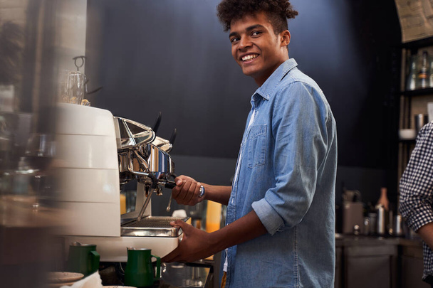 Barista looking at his clients with a satisfied smile - Foto, Imagem