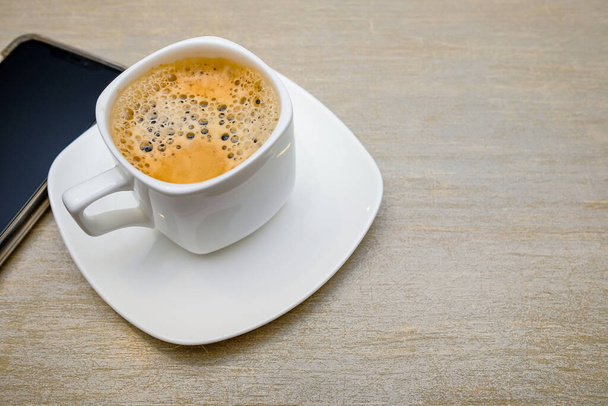A cup of coffee  with milk served on the table - Photo, image