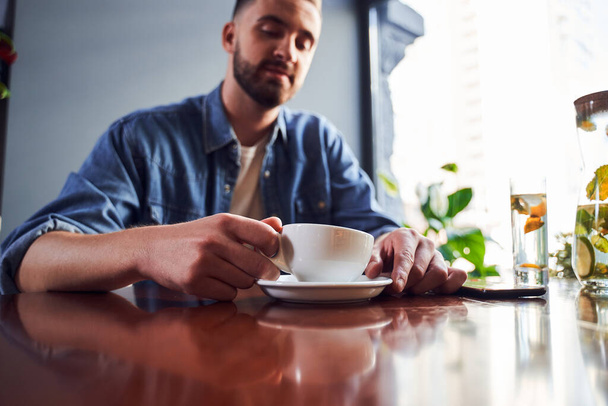Low angle of man with beard drinking coffee - Foto, Imagen