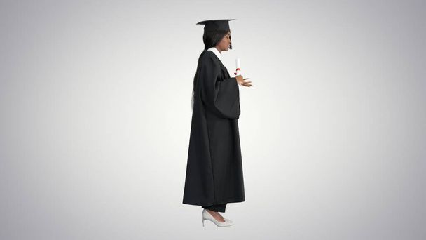 African American female graduate holding diploma and giving spee - Фото, зображення