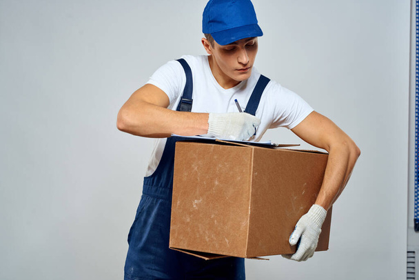 Man worker with box in hands delivery loading service packing service - Fotó, kép