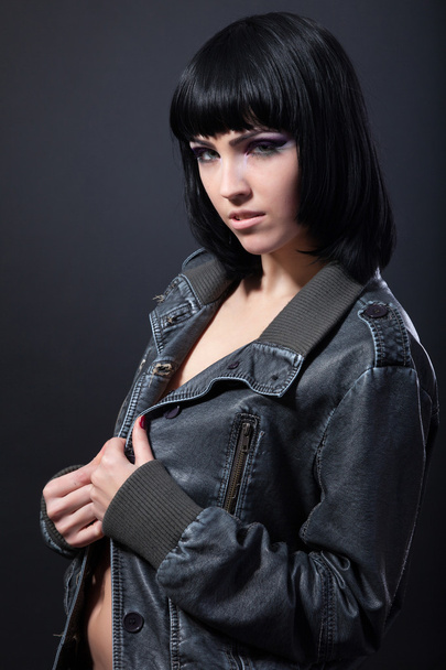 Brunette woman in a leather jacket - Фото, изображение