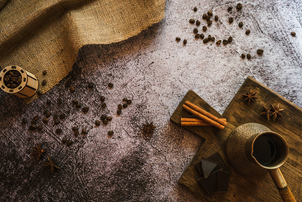 ingredients for making coffee, cinnamon, chocolate, spices on a brown wooden board 6 - Fotografie, Obrázek