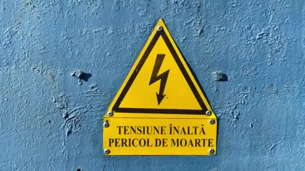 Close-up of yellow  high voltage sign on blue door. - Footage, Video