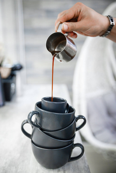 Cup of invigorating espresso in the morning. Preparing espresso coffee in an unusual way. - Photo, image