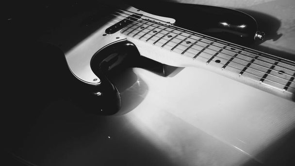 electric guitar closeup in the stage light . black and white                                - Foto, afbeelding