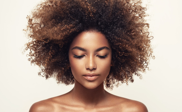 Beautiful African American woman with afro hair - 写真・画像