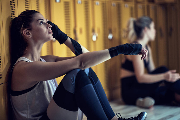 Young girl chilling in a locker room after strenuous training - Photo, image