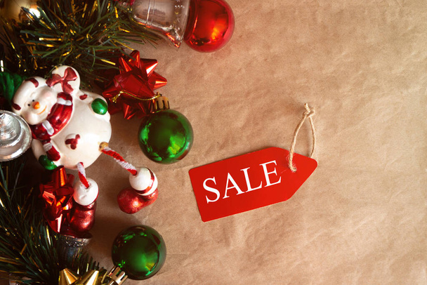 christmas tag with sale on xmas decoration with, christmas toys and balls. flat lay - Valokuva, kuva