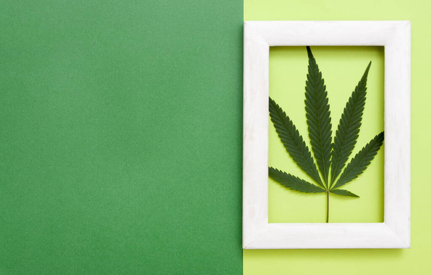 vista superior da folha de cannabis em quadro branco sobre fundo de papel com espaço de cópia - Foto, Imagem