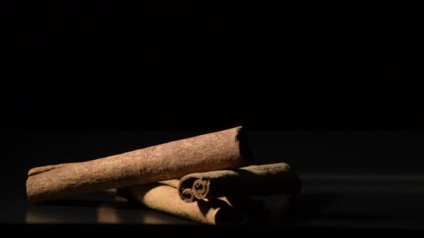 Sticks of cinnamon rotating in black bakground - Footage, Video
