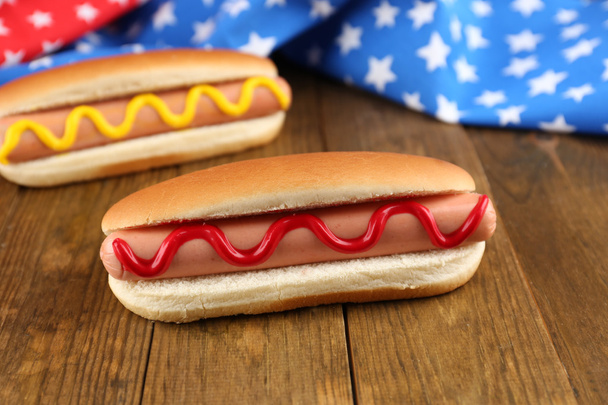 Tasty hot dogs on wooden table - Photo, image