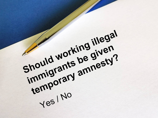 One person is answering question about immigration. He is thinking if working illegal immigrants should be given temporary amnesty. - Photo, Image