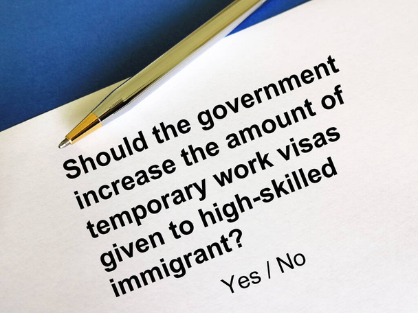 One person is answering question about immigration. He is thinking if the government should increase the amount of temporary work visas given to high skilled immigrant. - Photo, Image