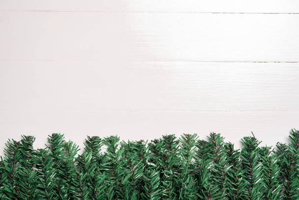 artificial Christmas tree leaf decorate on white wooden background - Φωτογραφία, εικόνα