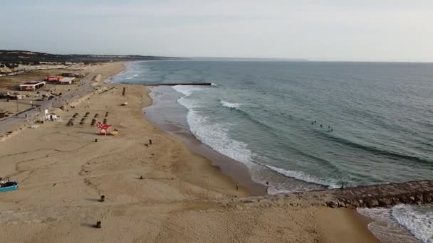 Aerial video in motion of sunset in the Atlantic Ocean in Costa da Caparica, Lisbon, Portugal. Aerial of the beach and sunset during the sunset. - Footage, Video