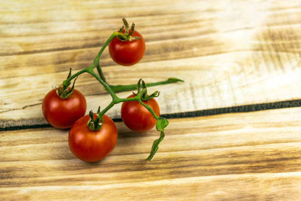 Tomatoes on a wooden background. Close up - Photo, image