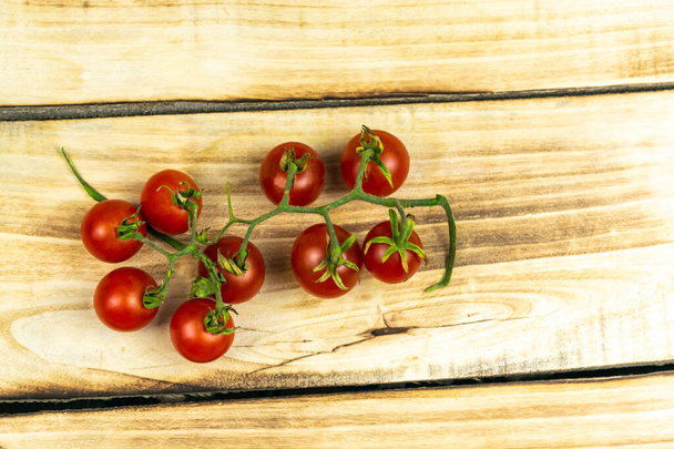 Tomatoes on a wooden background. Close up - Valokuva, kuva