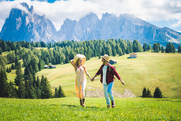 Beautiful young couple travelling in the Dolomites, Italy - Two lovers having a day trip in the nature - Фото, зображення