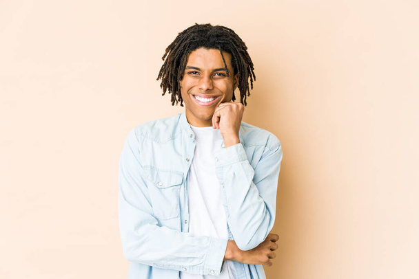 Young african american rasta man smiling happy and confident, touching chin with hand. - Photo, Image