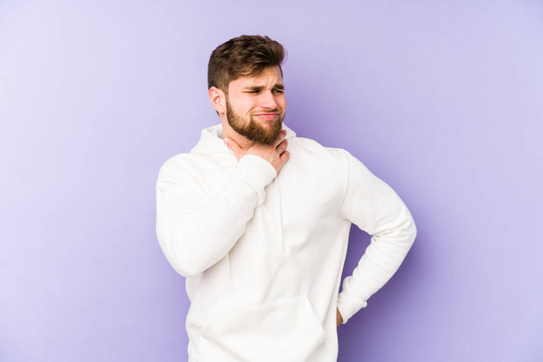 Young caucasian man isolated on purple background suffers pain in throat due a virus or infection. - Photo, Image