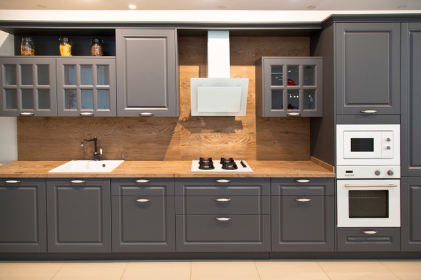 Interior of luxurious modern kitchen equipment and grey cabinets - Fotografie, Obrázek