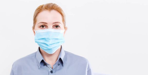 woman with a medical mask for protection again influenza. Shallow depth of field. Copy space for your text. - Фото, изображение