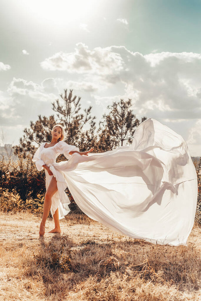 Beautiful woman in white dress - Fotó, kép