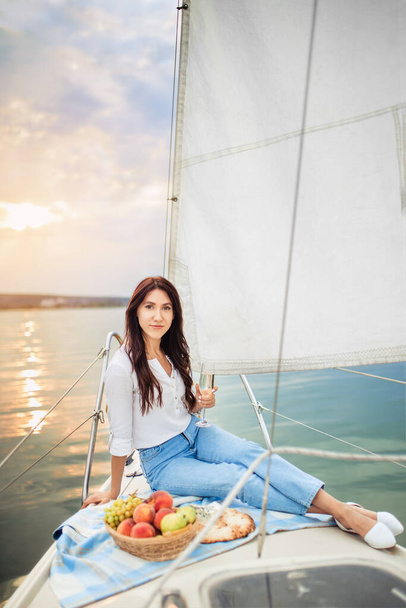 woman with glass of champagne resting on yacht - Foto, immagini
