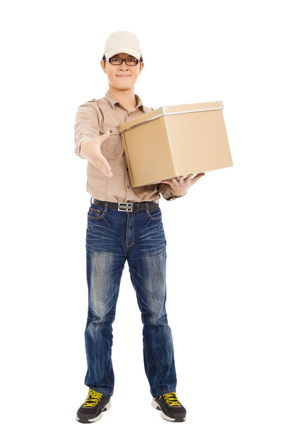 smiling  delivery man holding parcel and standing - Photo, Image