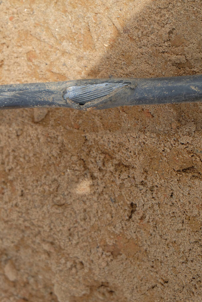 Electric cable repair, open trench with damaged cable on its bottom . - Photo, Image