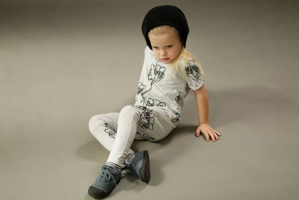 Studio shot of 3 years old fashionable kid on the grey background - Фото, изображение