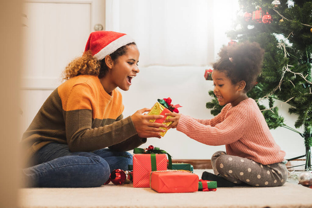 Mladá černošky africký matka dávat vánoční dárek box na její dceru, Veselé Vánoce a šťastný nový rok koncept - Fotografie, Obrázek