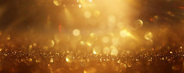 background of abstract gold and black glitter lights. defocused - Foto, imagen