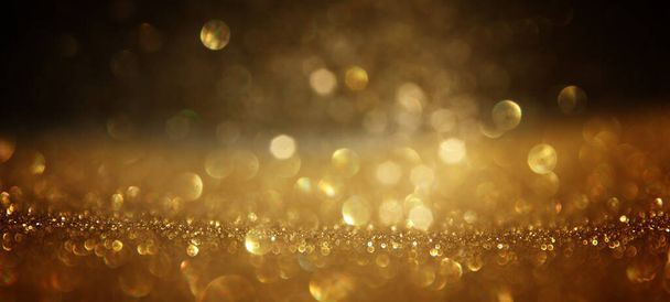 background of abstract gold and black glitter lights. defocused - Fotografie, Obrázek