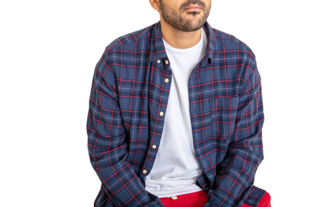 Half face of handsome young man with beard wearing blue plaid shirt sitting isolated on white background. Brunette guy with casual style. Front view. - Fotoğraf, Görsel