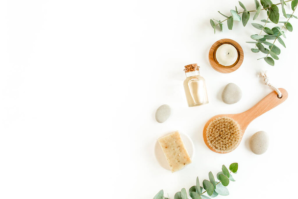 Spa Background. Natural, Organic spa cosmetics products, eco friendly bathroom accessories, eucalyptus leaves. Skincare concept on white background.  - 写真・画像