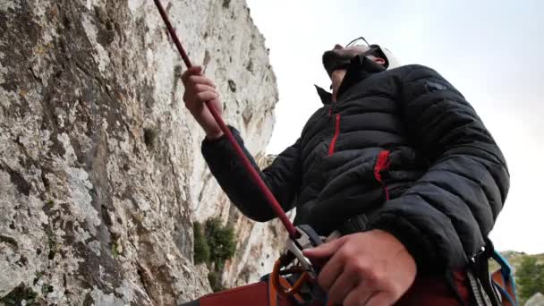 Man belaying his climbing partner in Betlem, Mallorca, Spain.High angle, parallax movement, 4K 60p. - Footage, Video
