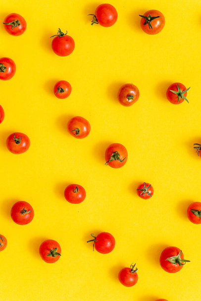 small cherry tomatoes on the yellow background - Φωτογραφία, εικόνα