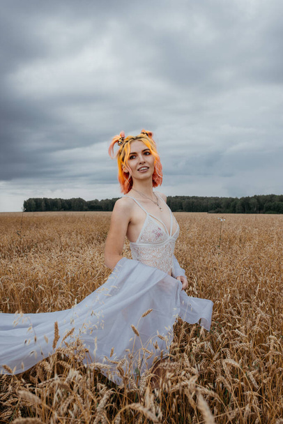 girl with colored hair in underwear in a wheat field - 写真・画像
