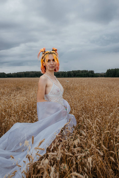 girl with colored hair in underwear in a wheat field - Photo, Image