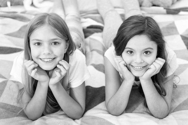 Free your smile. Little girls smile relaxing on bed. Happy children smiling. Dental care. Dentistry for kids. Keeping teeth white and clean. Smile a happy smile - Foto, immagini