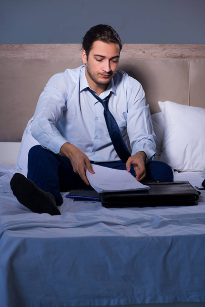Tired businessman working overtime at home at night - Φωτογραφία, εικόνα