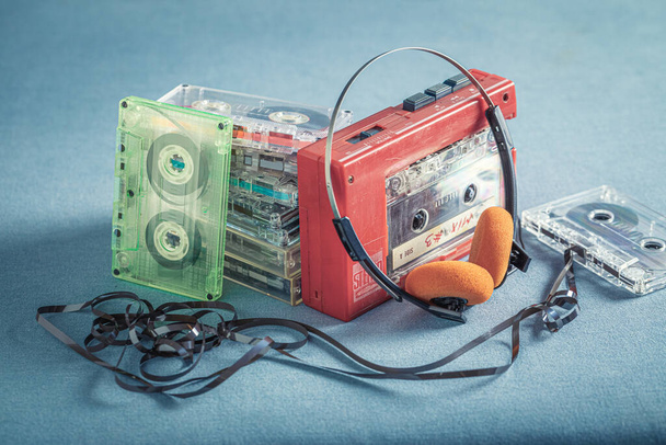 Antique cassette tape with headphones and player on blue sofa - Φωτογραφία, εικόνα